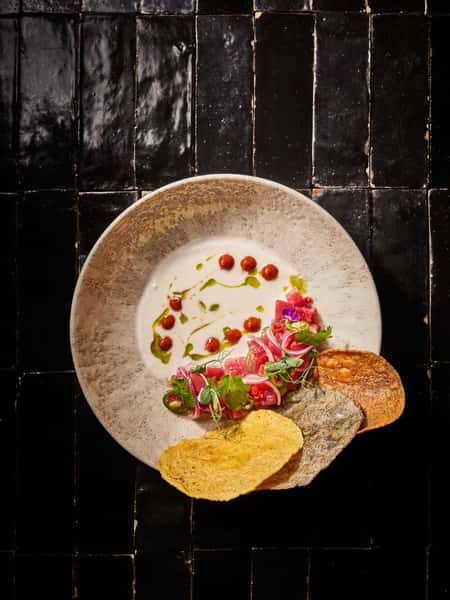 Saucy bowl served with crispy side dishes