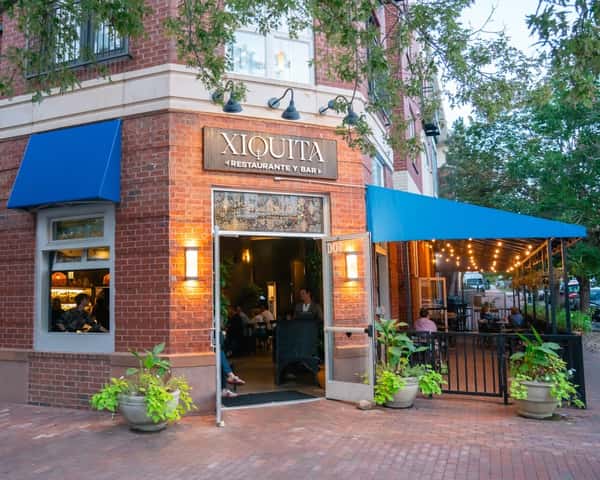 Restaurant exterior with outdoor seating and warm lighting