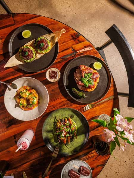 Mixed Mexican food spread on a dark wooden table