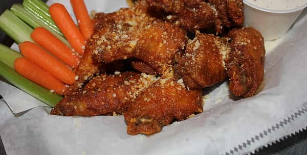 basket of wings with carrots and celery