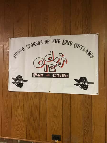 sponsor of eerie outlaws sign posted on wooden wall