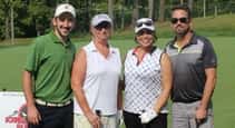 four people on golf course