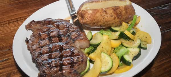 steal potatoes and veggies on a white plate