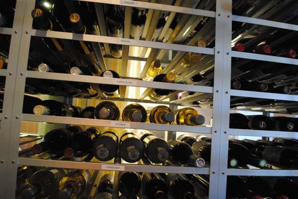Wine bottles stacked on a wine shelf