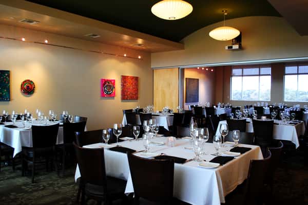 Dining room with tables, chairs and white tablecloths