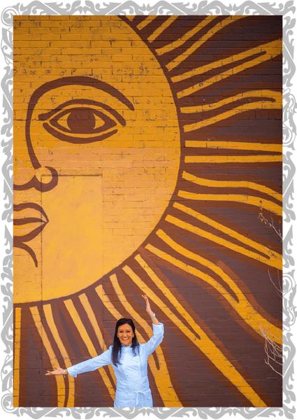chef in front of wall mural of sun