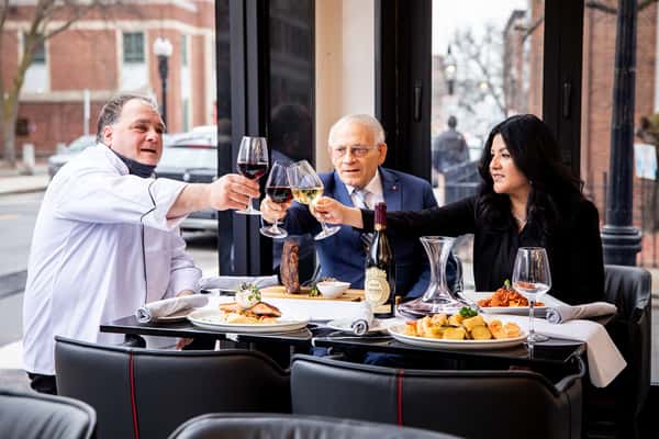 three people enjoying food