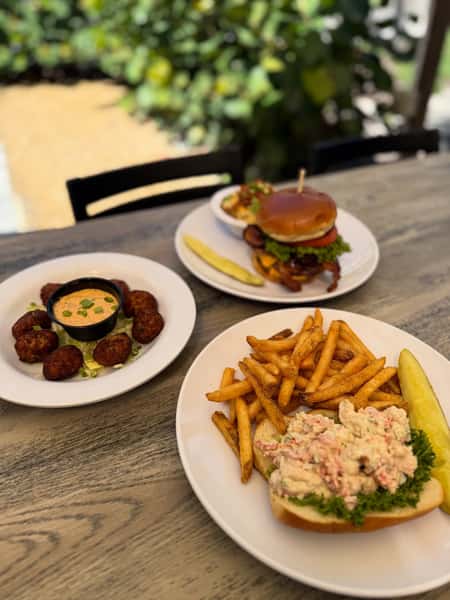 Casual seafood and bar favorites including a lobster roll with fries, crispy croquettes, and a signature burger at The Boxer Kitchen & Bar.
