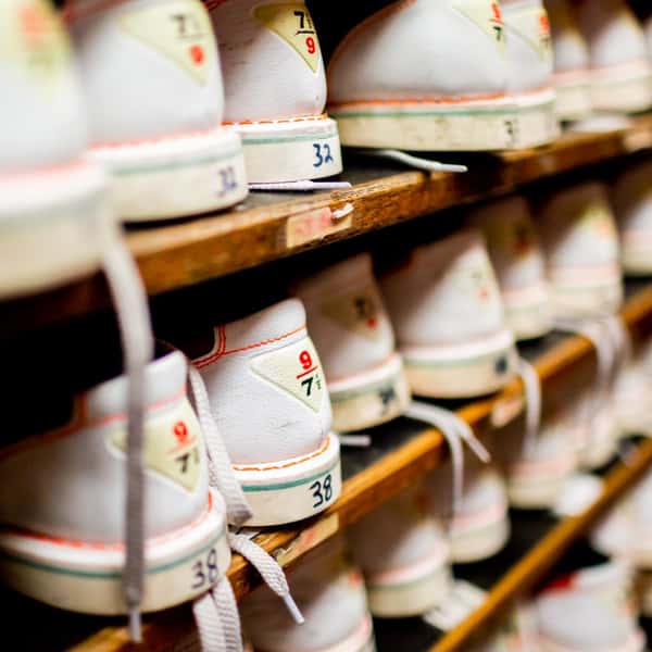 rental bowling shoes on a shoe rack