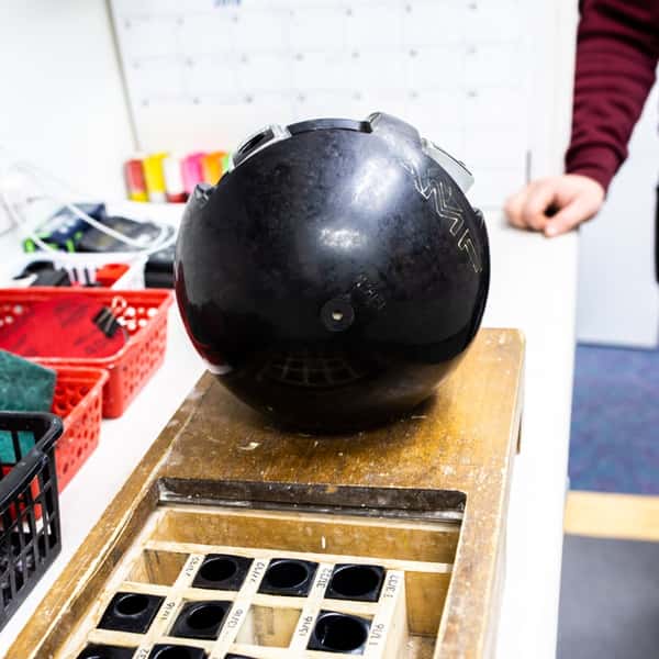 man polishing a bowling ball