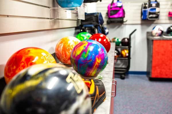 multicolored bowling balls on a rack