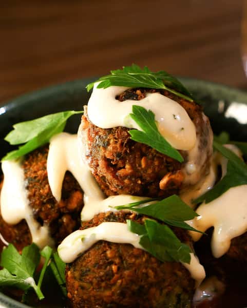 Crispy fried oyster bites topped with creamy remoulade and fresh parsley, served as a Southern seafood appetizer.