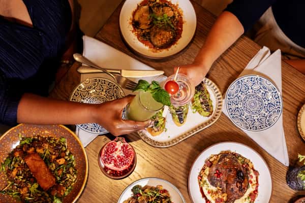 toasting over table of food