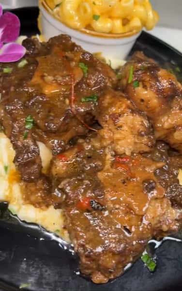 Braised Oxtails over rice with 1 side