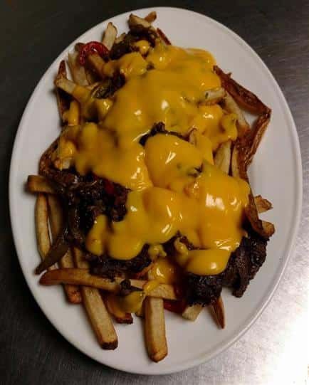 meat topped with melted cheese, topped on french fries