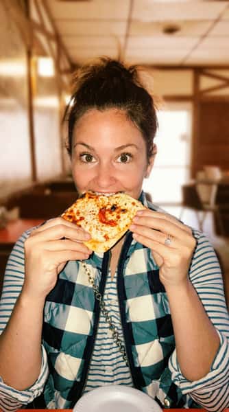Customer happily eating pizza