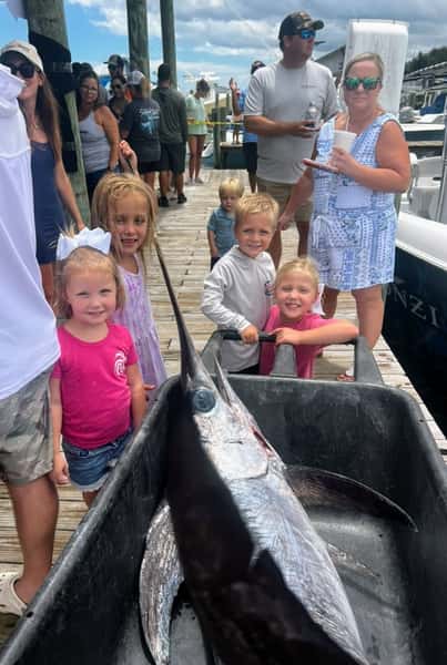 kids with swordfish