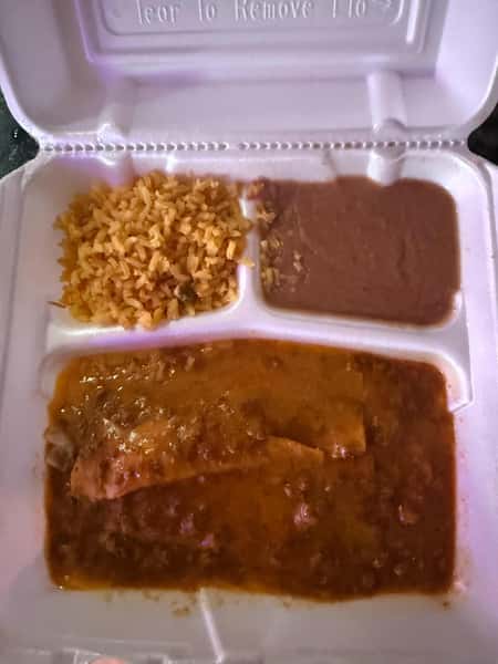 Takeout container with Mexican enchiladas topped in red chili sauce, served with refried beans and seasoned Mexican rice.