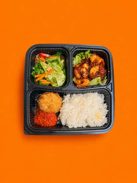 Malaysian sambal prawn set meal with white rice, spicy prawns, vegetables, and traditional sides served in a convenient bento-style container.
