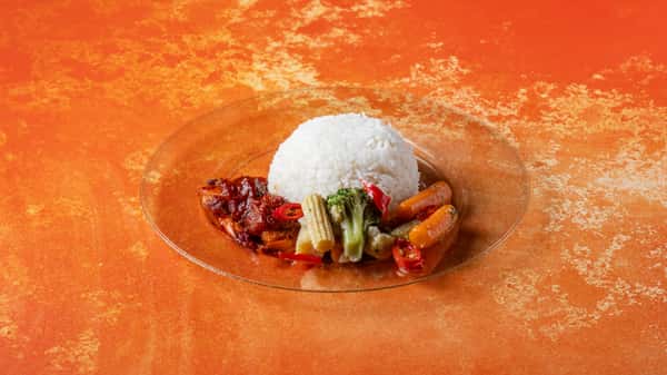 Authentic Malaysian rice meal featuring white rice, sambal, mixed vegetables, and savory traditional accompaniments.