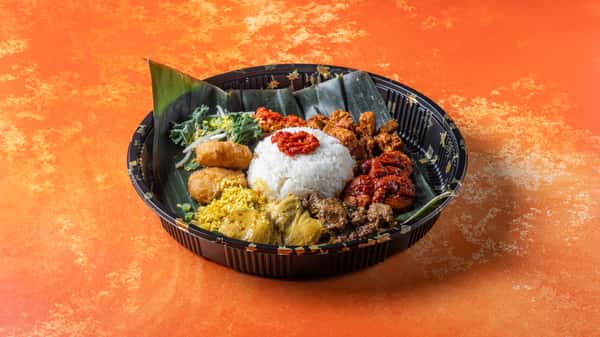 Traditional nasi ambeng platter for two featuring coconut rice, sambal, fried chicken, vegetables, and assorted Malaysian side dishes.