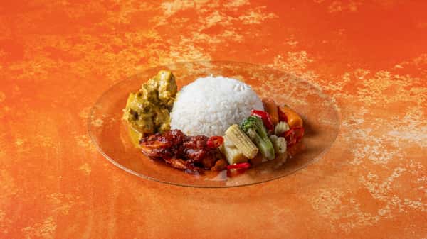 Authentic Malaysian rice plate with white rice, spicy sambal, curried vegetables, and traditional side dishes served on an orange backdrop.