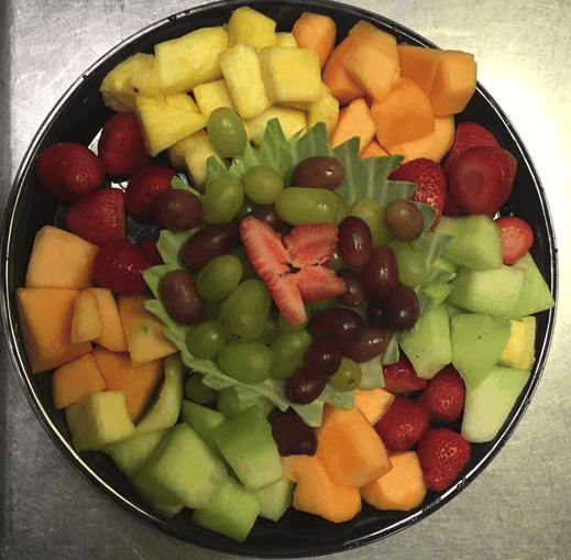 Assorted fruits and grapes on party platter tray