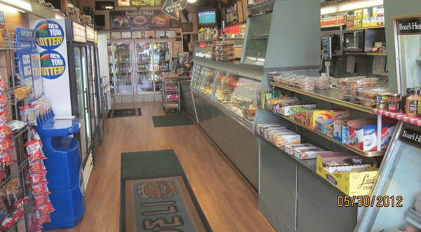 Shelves of deli with chips, candy, and deli window