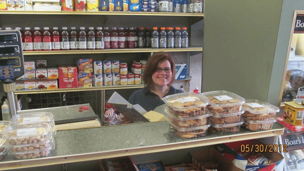 Interior of Deli with friendly woman at the counter