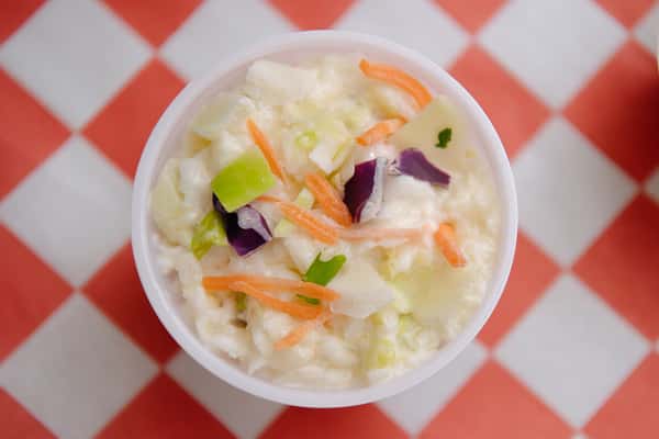 Fresh coleslaw made with cabbage, carrots, and creamy dressing.