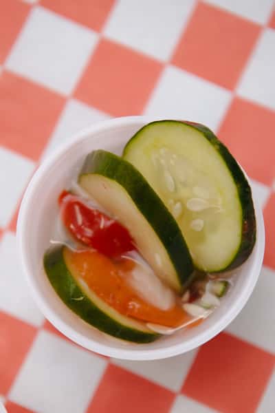 Fresh cucumber and tomato salad served as a side dish.