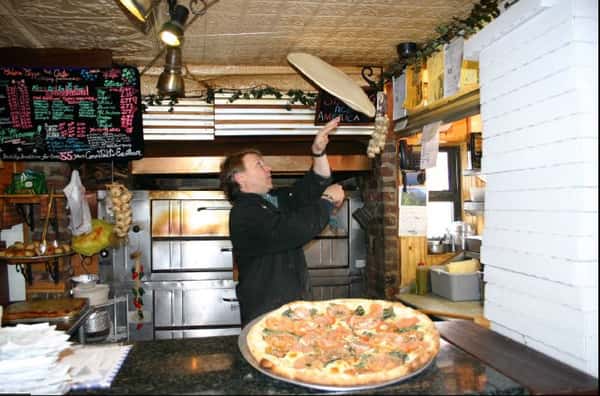 Anthony spinning a pizza