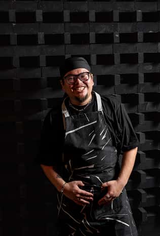 Smiling team member in an apron