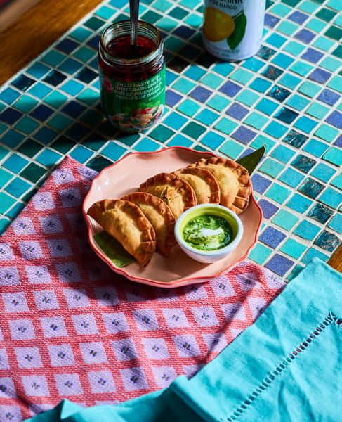 The Avo Moon Shine: smooth meets spicy. Crispy dumplings filled with avocado, ground chicken and spices. Served with cilantro cashew chutney and sour cream.