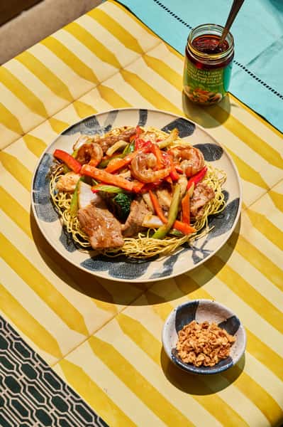 Crunch first, saucy bliss after. The Crispy Chiang Mai: crispy egg noodles drowned in our bold signature sauce, topped with chicken, beef, and shrimp. Stir-fried with bell peppers, broccoli, carrots, celery, and onions.
