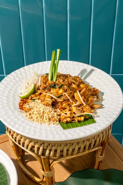 Pad Thai: the classic crowd-pleaser. Stir-fried rice noodles tossed with egg, bean sprouts,green onions in our signature sweet-tangy tamarind sauce. Finished with crushed peanuts and fresh lime. Comforting, vibrant, and oh-so craveable.