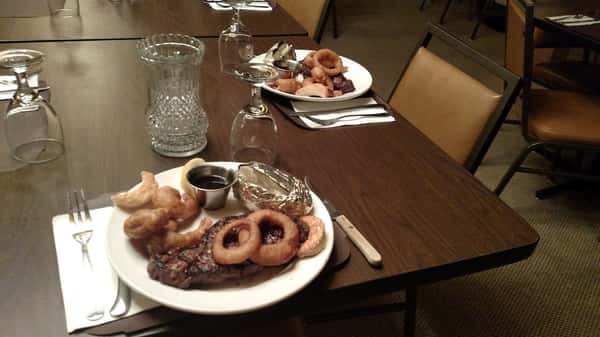 Grilled steak served with onion rings