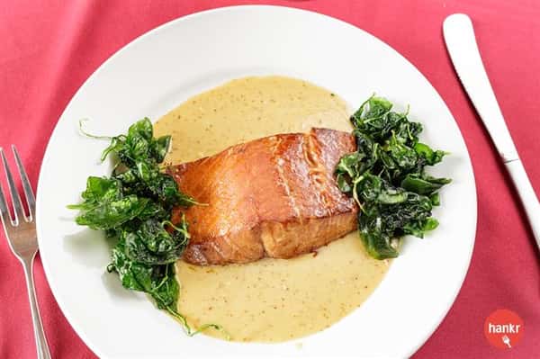 Salmon served with greens and salsa