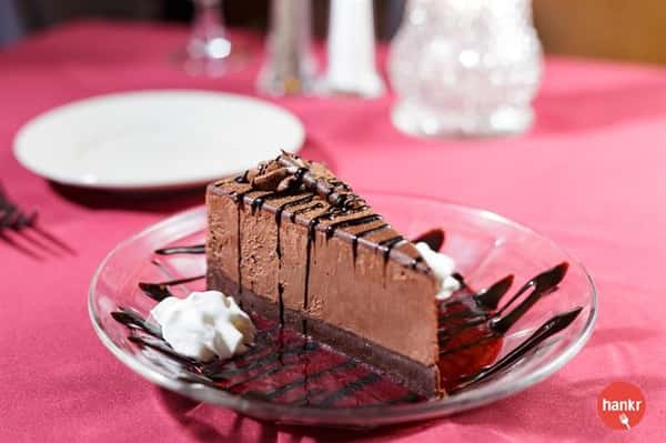 A piece of chocolate cake with chocolate syrup