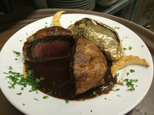 beef wellington with baked potato