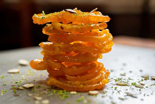 A spiral shaped crunchy sweet dipped in saffron laced sugar syrup.