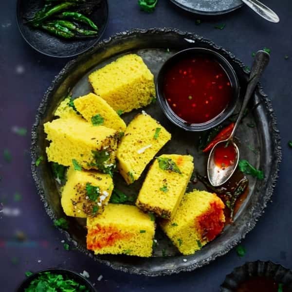 assortment of chopped Moong Dal Barfi with dipping sauce