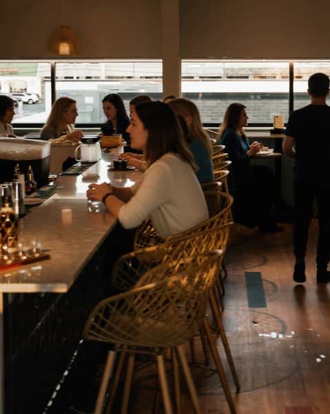 guests sitting at bar