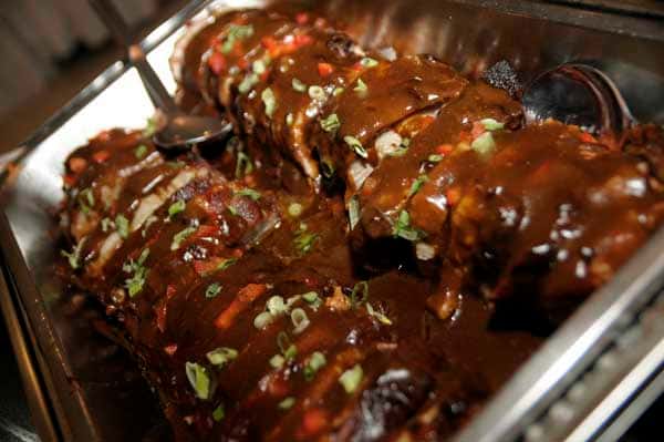 catering display of meatloaf with sauce and herbs