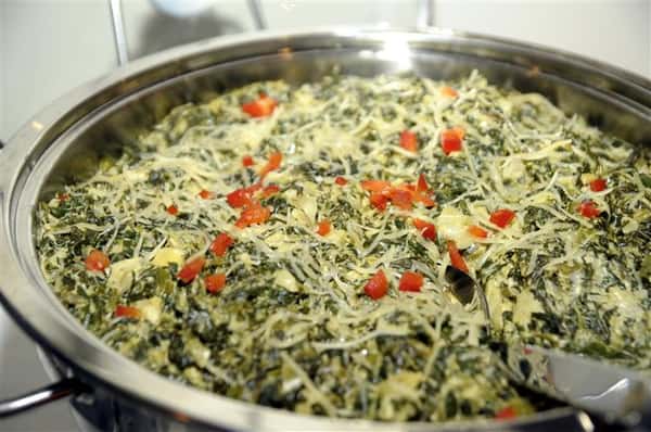 metal catering display of spinach and artichoke dip