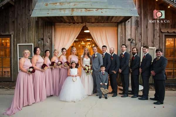 bridal party with bride and groom standing together for a group photo