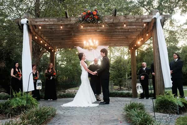 outdoor wedding ceremony with the bride and groom at the alter with the wedding party