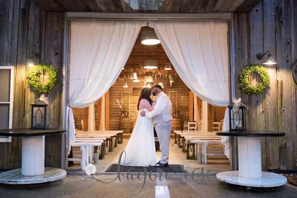 bride and groom indoors kissing taking a wedding photo together