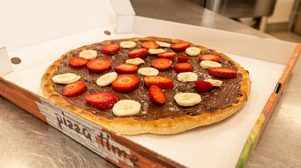 Sweet dessert pizza topped with chocolate spread and fresh strawberries from Ciao Bella in Westhill