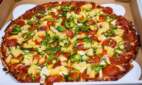 Hand-tossed pepperoni pizza topped with pineapple, fresh jalapeños, melted mozzarella, and a golden baked crust for a sweet and spicy flavor.